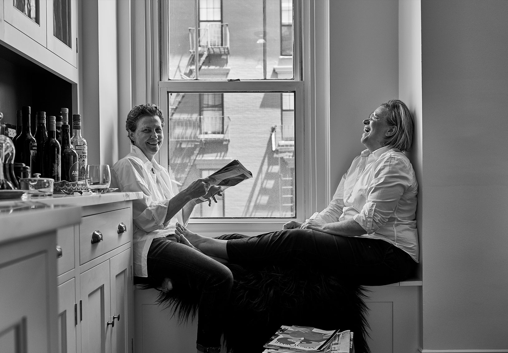 Friends laughing in kitchen